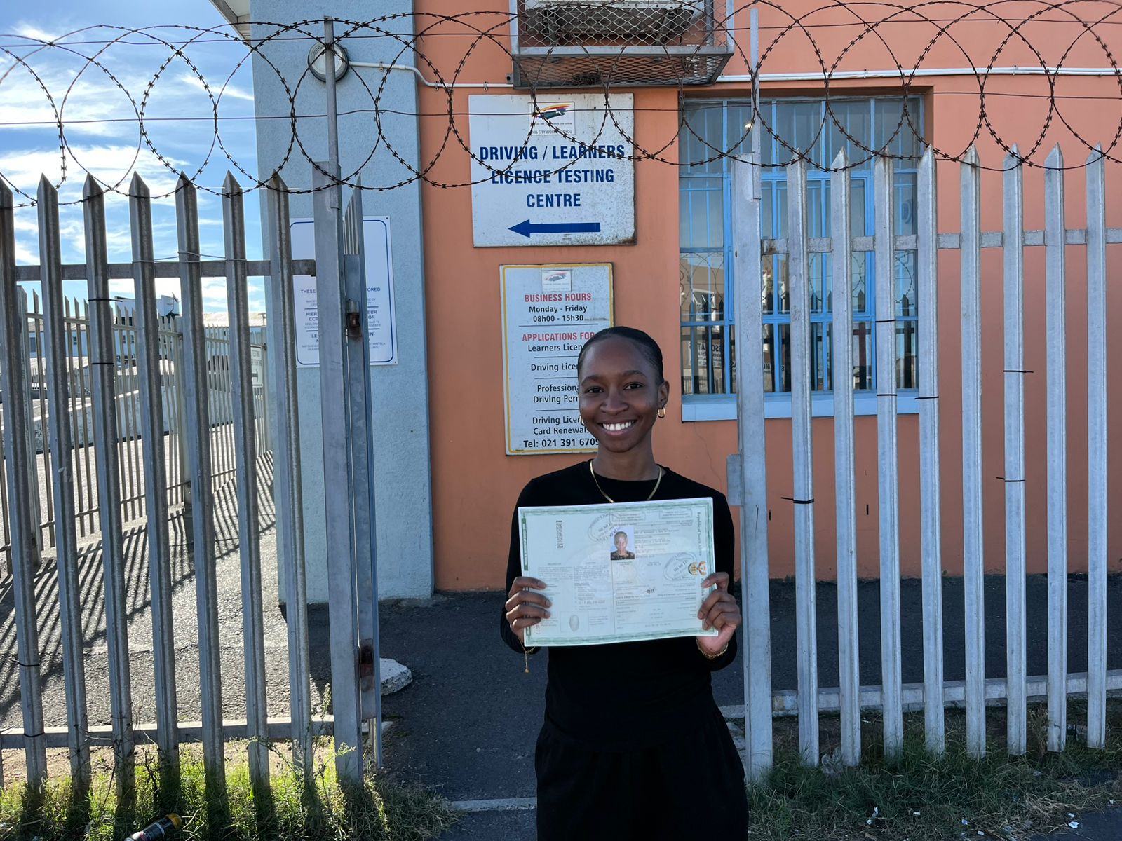 Student proudly holding acquired driving certificate